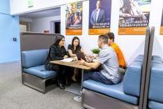 students conversing around a table