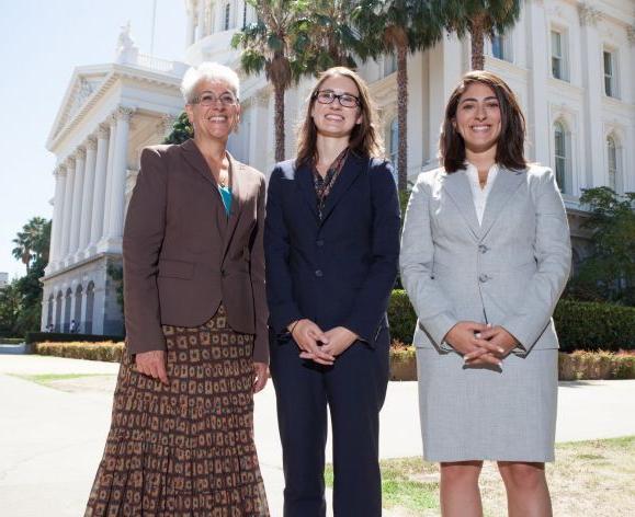 three students in front of the capitol