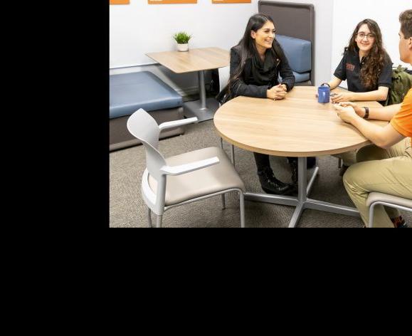 education students sitting around a table talking