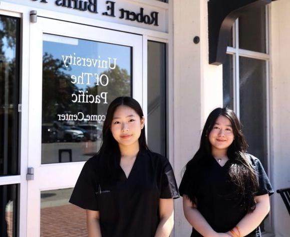 two pre-health students in front of burns tower