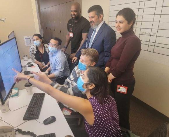 people gathered around monitor looking at sleep study results