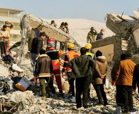 Image shows a team of responders working on saving earthquake victims from a building.